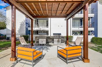 A patio with two chairs and a table.